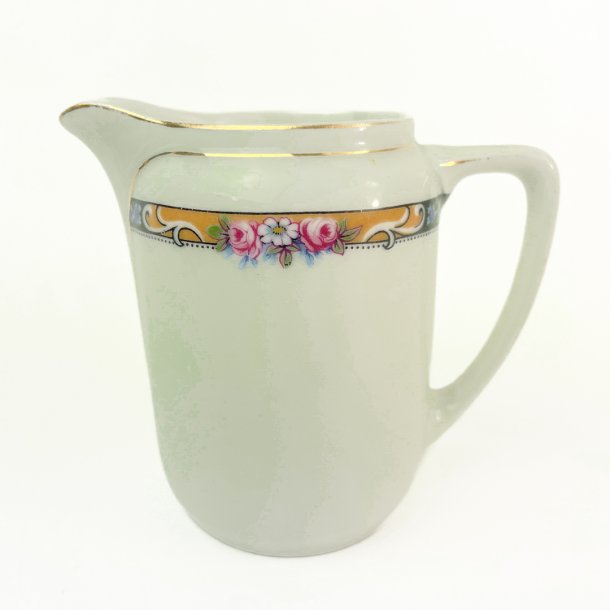 Lille vintage kande med blomsterbort