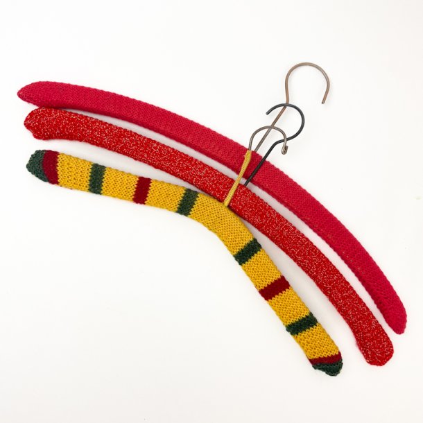 Drei rote und gelbe Retro-Kleiderbgel mit Strickberzug